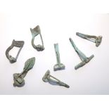 A collection of seven ancient Roman bronze brooches.