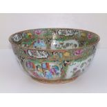 A 19thC Cantonese porcelain punch bowl, decorated with panels depicting butterfies and figures on