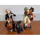 A Royal Doulton black glazed pelican, the Fiddler HN2171 and the Cellist HN2226 - one foot re-stuck.