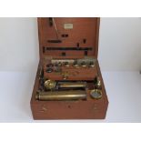 A 19thC brass field microscope with accessories in mahogany box labelled for Watkins & Hill,