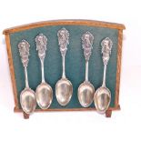Five presentation silver teaspoons decorated with a fighting cockerel 'NCC' on wooden stand.