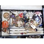 A plastic box containing costume jewellery.