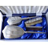 A modern silver dressing table brush set.