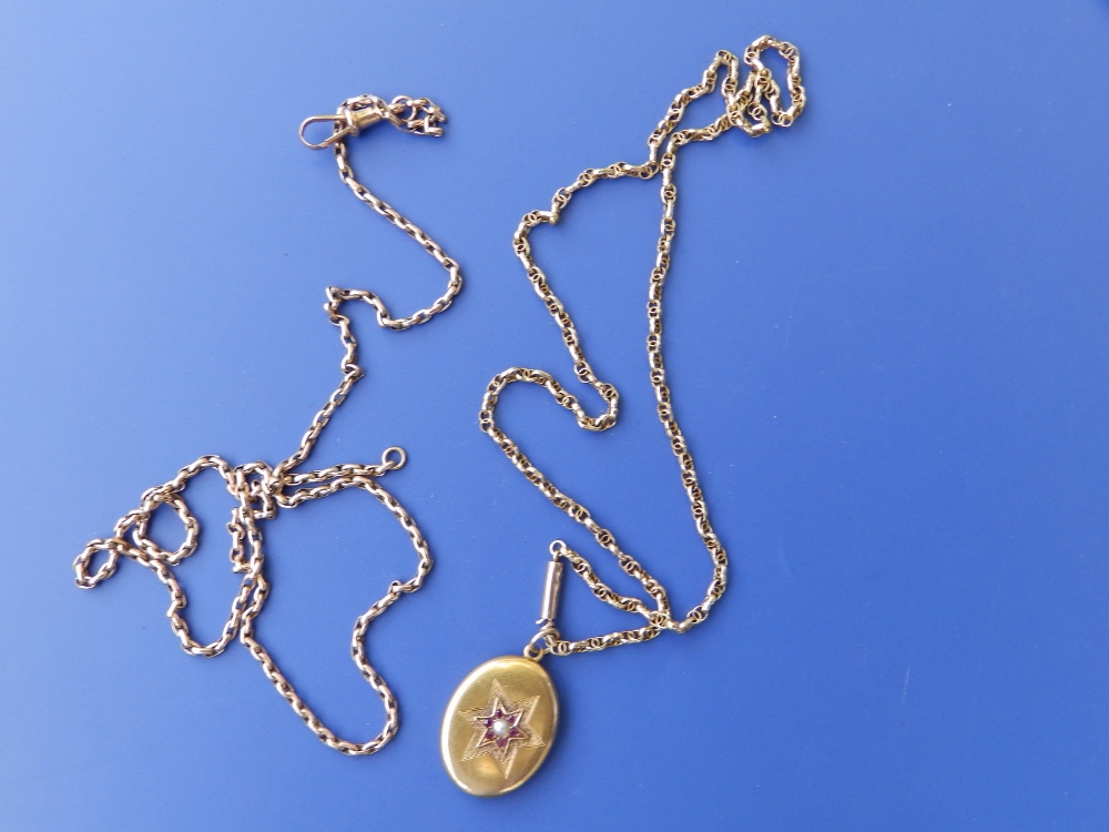 Two yellow metal necklace chains and an oval locket. (3)