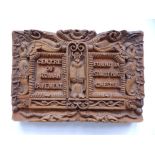 A small rectangular wooden plaque with high relief decoration 'Centre of Roman Pavement found in
