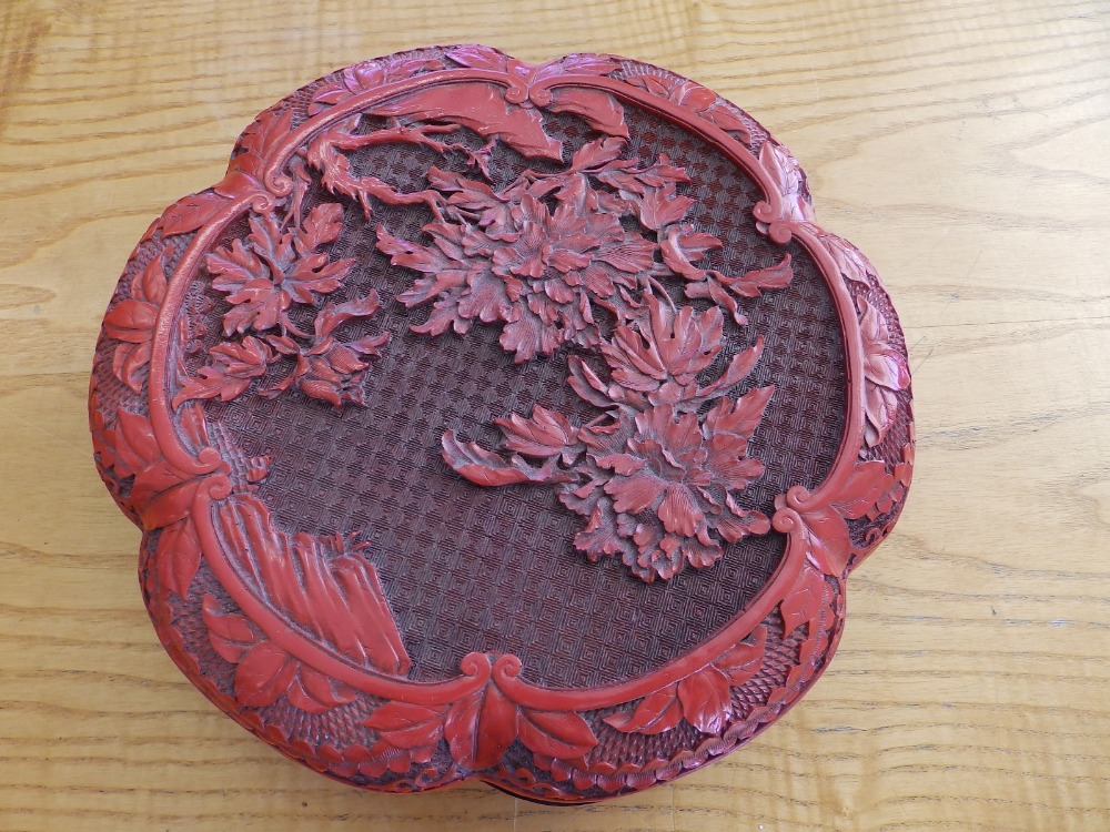 A 20thC cinnabar lacquer circular box with cover, 9.75" diameter.