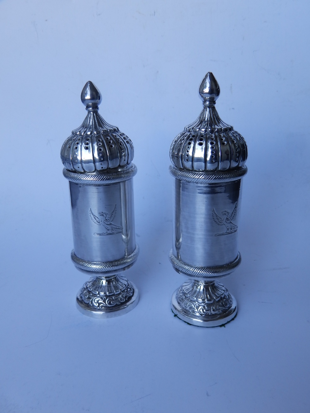A pair of domed silver plated pepperettes in the Russian style and three shell-shaped salts. (5)