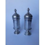 A pair of domed silver plated pepperettes in the Russian style and three shell-shaped salts. (5)