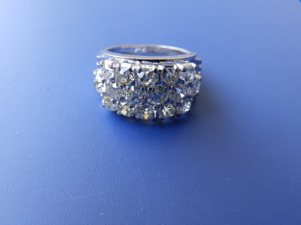 A modern Chinese diamond set '18k' white metal ring, the 16 brilliants slightly off white in