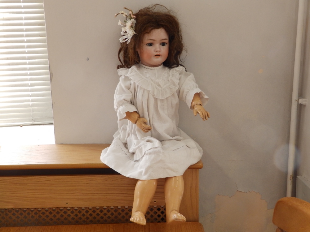 A late 19thC Simon & Halbig bisque head girl doll 1078 size 13, having pierced ears, blue sleeping