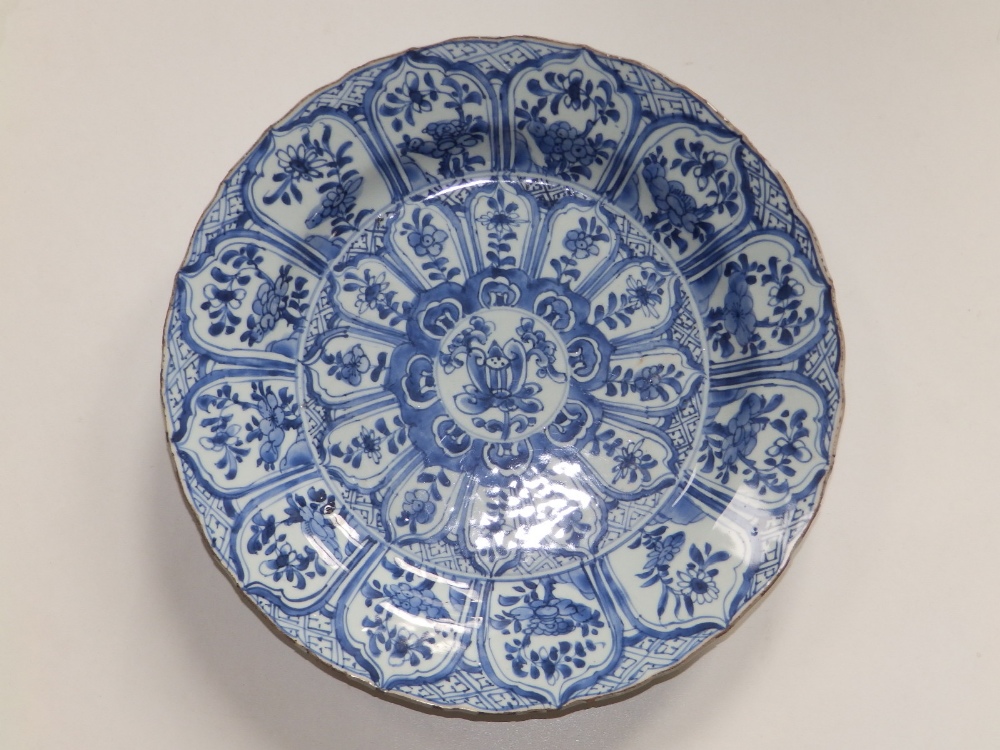 A Chinese blue & white kraak porcelain charger, decorated with three rows of floral lappets around a