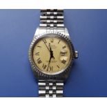 A boxed gent's stainless steel Rolex Oyster Datejust with champagne dial black roman numerals having