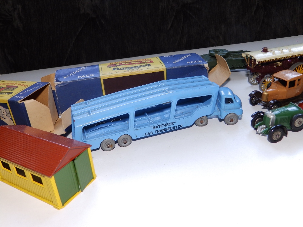 A boxed Matchbox Car Transporter, a boxed Garage, a Tank Transporter and five Models of