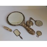 An embossed silver hand mirror - Birmingham 1906, a miniature Birmingham silver mirror, two