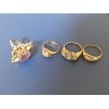 Four gem set gold rings - two with missing diamonds.
