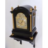 A late Victorian ebonised chiming bracket clock by M. F. Dent, the arched top with four gilt brass