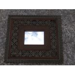 A rectangular Indian green stained wood 'Jali' mirror, 20" high.