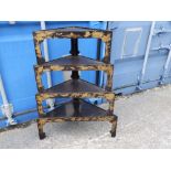An Oriental lacquered corner whatnot in four loose standing tiers, Width 28".