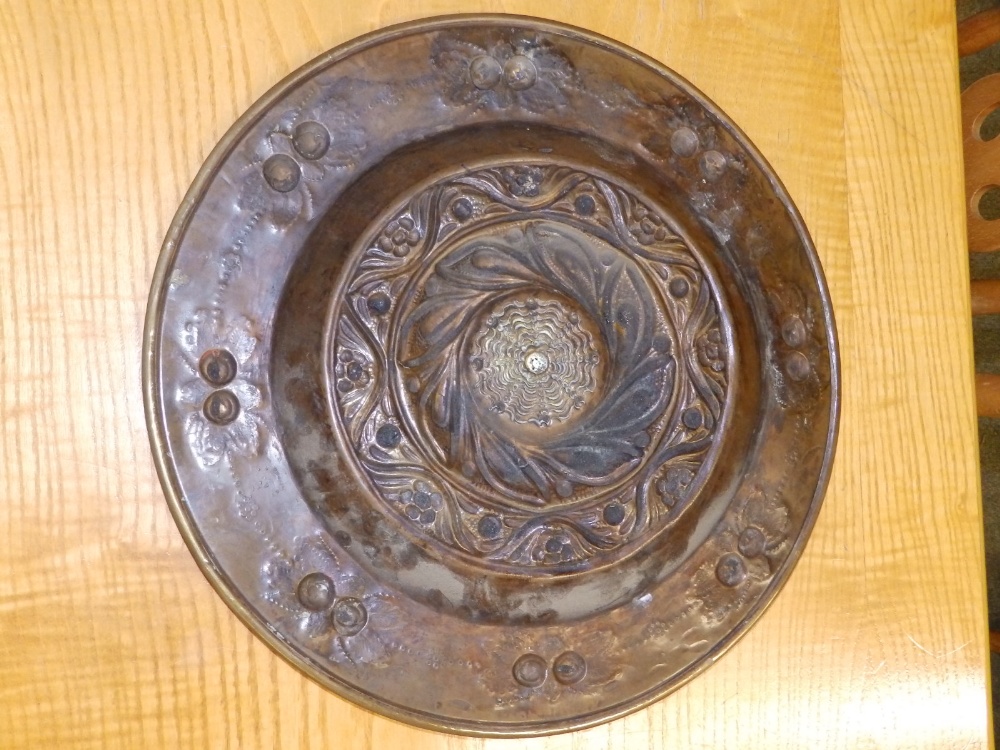 An embossed brass alms dish, 14" together with a beaten copper circular tray by H. Dyer, 11.5". (2) - Image 2 of 4