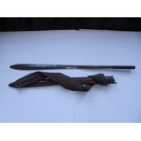An African Masai sword in leather scabbard, 30.5" overall.