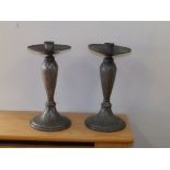 A matched pair of Tudric beaten pewter candlesticks , 9.5" - one stem a/f.