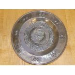 An embossed brass alms dish, 14" together with a beaten copper circular tray by H. Dyer, 11.5". (2)