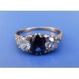 A three stone sapphire & diamond ring, the cushion cut sapphire flanked by two old cut diamonds