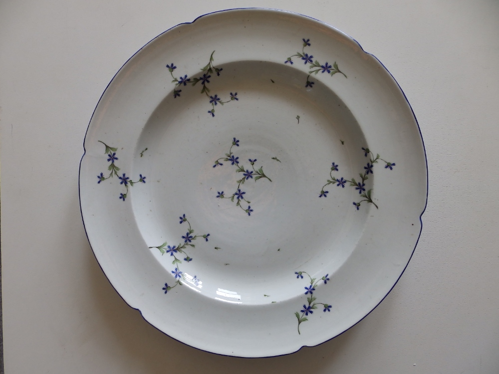 A Ludwigsburg porcelain charger, painted with scattered floral sprigs, blue painted rim, 13.8"