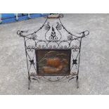 An art nouveau wrought iron fire guard.