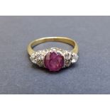 A ruby and diamond set yellow metal ring, the oval ruby flanked by six small old cut diamonds.