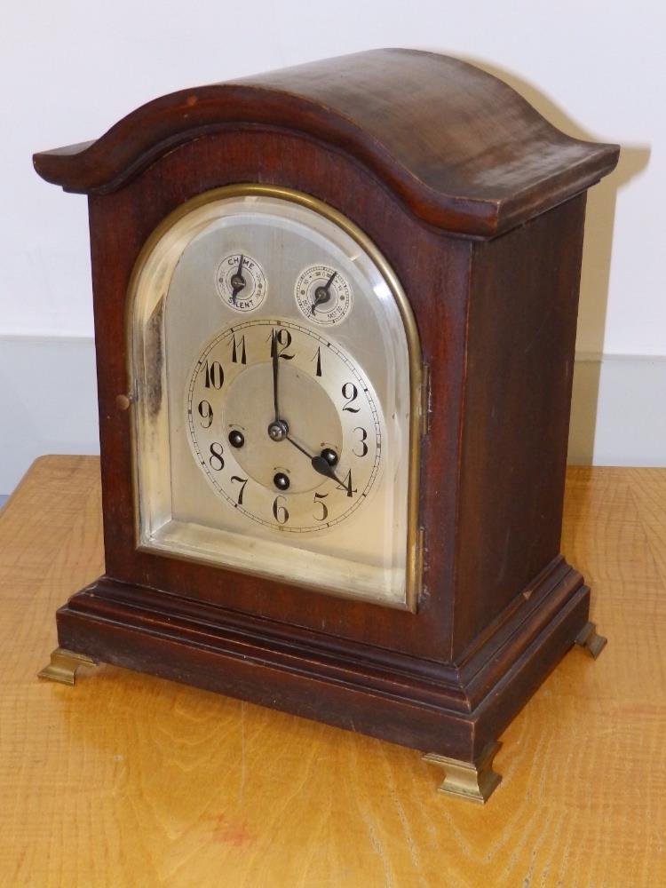 A German chining mahogany bracket clock with silvered dial by Junghans, Wurtenburg, 15" high.