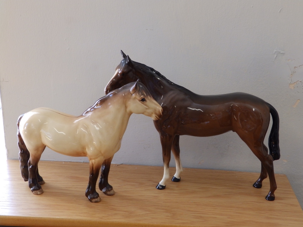 A Beswick 'Highland' horse and one other. (2)