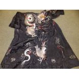 A Chinese black ground silk embroidered gown.