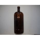 A moulded brown glass 'Poison' bottle, 12.5" high.