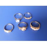Three Victorian pearl set rings, an opal ring and a paste solitaire. (5)