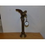 A silver fusee pocket watch on bird of prey stand.