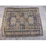 An old Oriental rug worked in blue & cream with three octagonal medallions in geometric design,