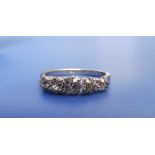 A five stone graduated diamond ring, the old cut diamonds claw set in 18ct white metal & 'PLAT', the