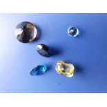 Five small unmounted cut coloured gemstones and a small quantity of related items of jewellery.