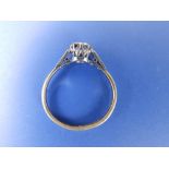 A diamond illusion set solitaire. Weighing approximately 0.30 carat, with small diamonds to