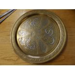 An Eastern brass wall plaque with silvered decoration, 15.5" diameter.