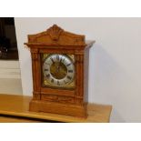 A Victorian oak repeating mantel clock.