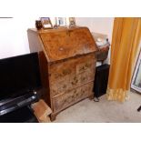 A small early 18thC walnut bureau, the sloping fall front enclosing fitted interior with well, above