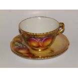 A Royal Worcester porcelain teacup painted fruit by C. Bowen and a saucer by J. Smith - C55. (2)