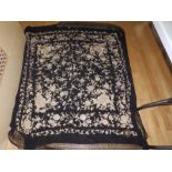 An embroidered black silk cover/shawl.