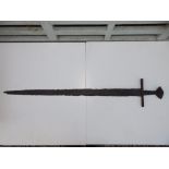 An 11thC Mediaeval sword, having remains of wood to hilt, 36" overall - in excavated condition.