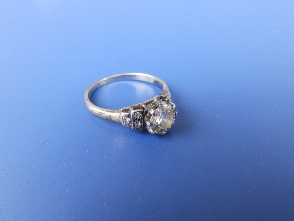 A diamond solitaire, the claw set brilliant weighing approximately 0.60 carat, small diamonds to