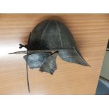 An antique lobster-tail helmet with two (detached) ear pieces.