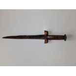 A 17thC kidney dagger with crudely patterned wooden hilt, 14" overall.