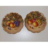 A pair of Royal Worcester fruit painted dessert plates by H. Ayrton with gilded fluted rims, 9". (